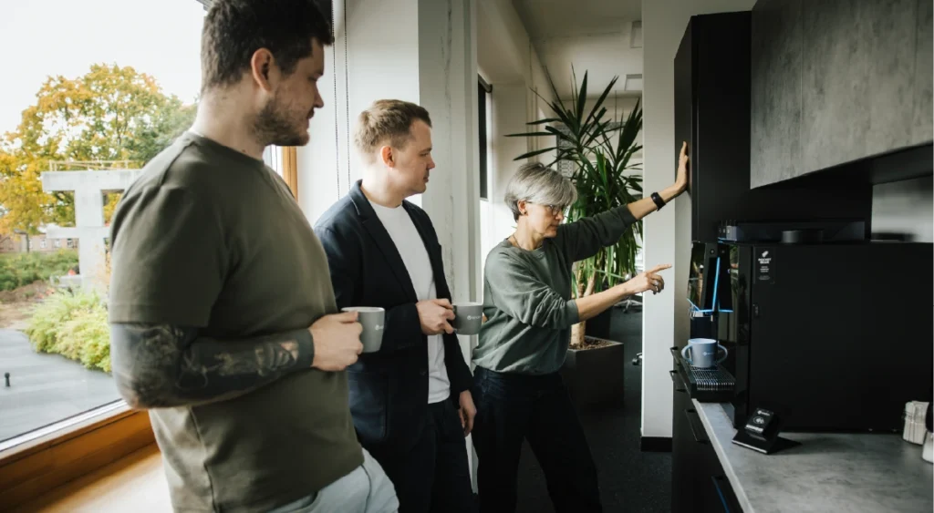 People standing around a vending machine