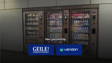 Geile Warenautomaten and Vendon teams standing beside a snack and drink vending machine, announcing their new partnership